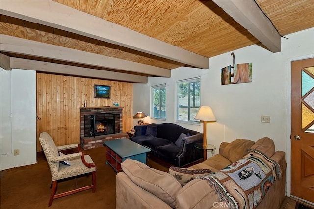 carpeted living room featuring beam ceiling, wooden ceiling, wood walls, and a fireplace