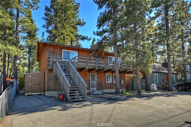 view of front facade with a storage unit and a deck