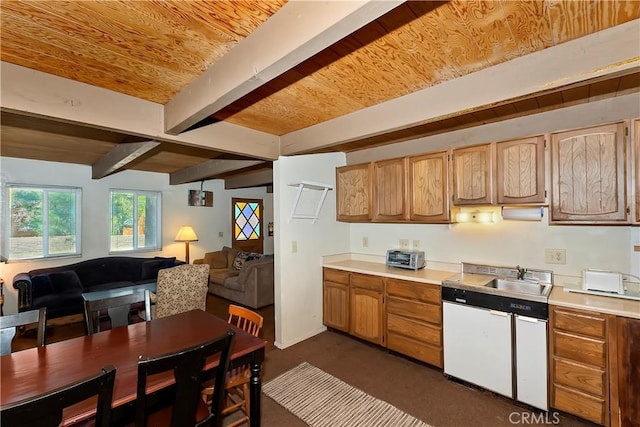 kitchen featuring beam ceiling and sink