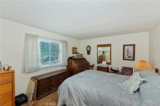 bedroom with light carpet and a textured ceiling