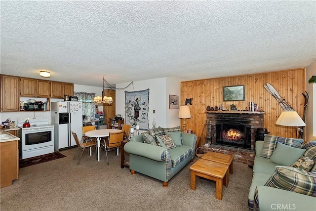 living room with a brick fireplace, a textured ceiling, wooden walls, and carpet flooring