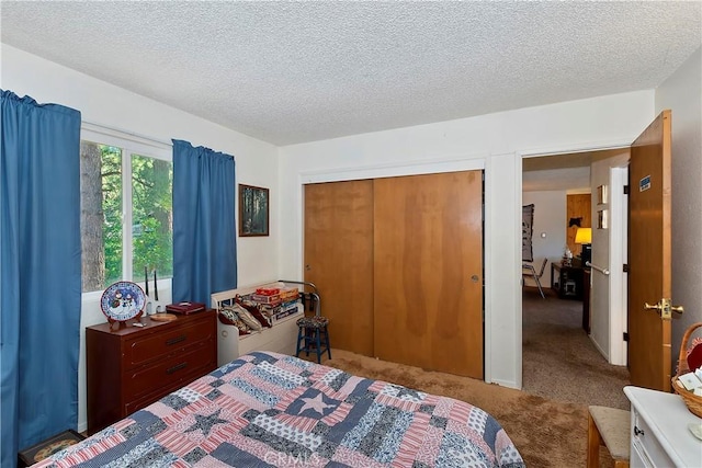 bedroom with carpet floors, a textured ceiling, and a closet