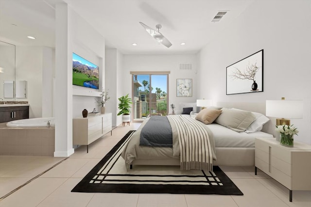 bedroom featuring light tile patterned flooring, ceiling fan, and ensuite bath