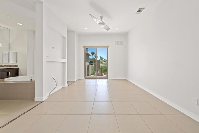 tiled spare room with ceiling fan