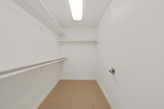 spacious closet with tile patterned floors