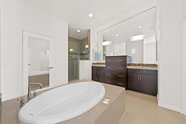 bathroom featuring vanity, tile patterned flooring, and separate shower and tub