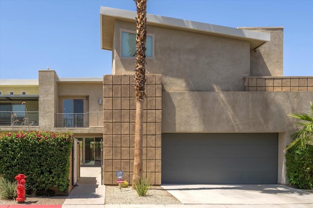 view of front of home with a balcony and a garage