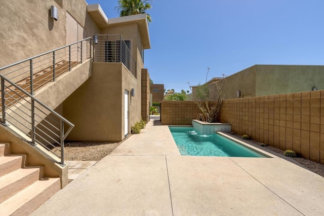 view of pool with a patio and pool water feature