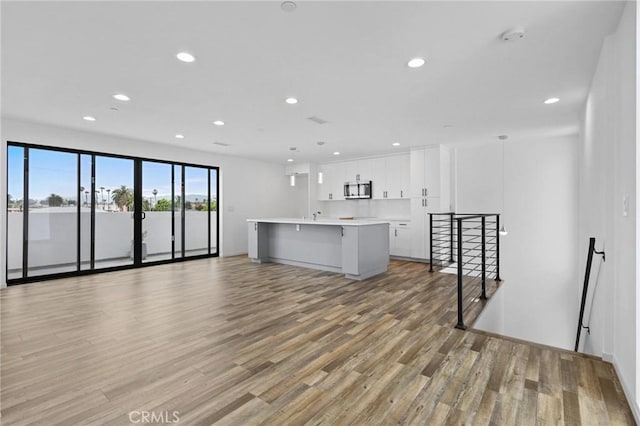 unfurnished living room with hardwood / wood-style floors