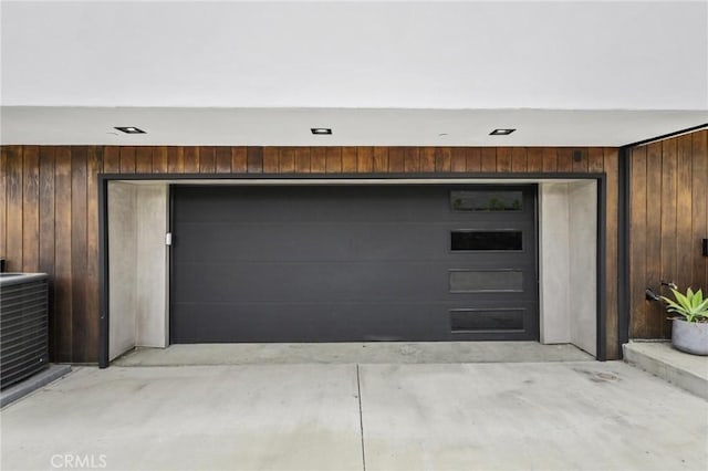 garage with central AC and wooden walls