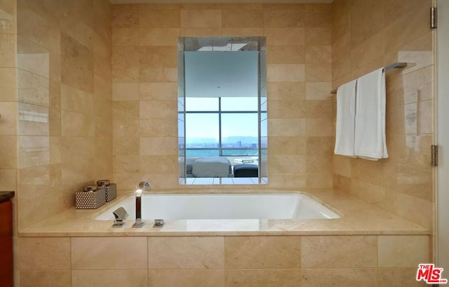 bathroom featuring a relaxing tiled tub