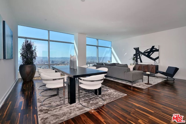 living room with dark hardwood / wood-style flooring, a wall of windows, and plenty of natural light