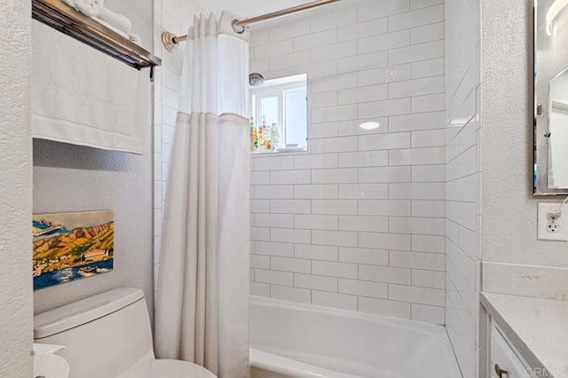 full bathroom featuring shower / bath combo with shower curtain, vanity, and toilet