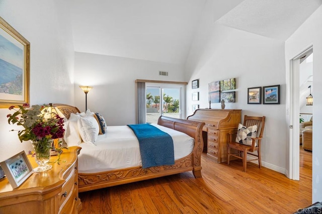 bedroom with high vaulted ceiling, access to exterior, and wood-type flooring