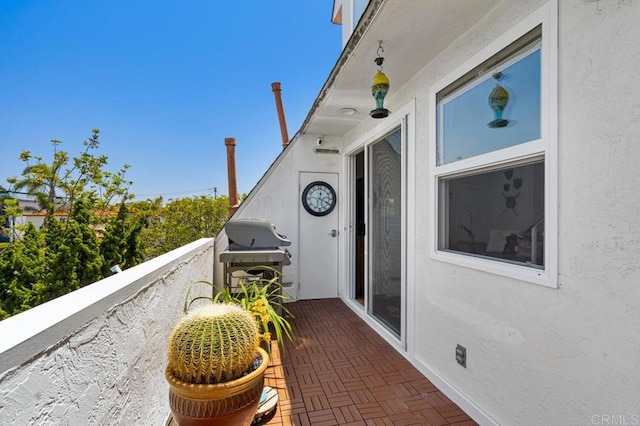 view of patio with a grill and a balcony