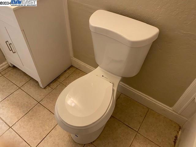 bathroom with tile flooring and toilet