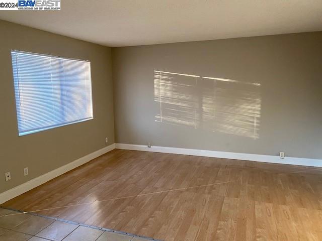 empty room with wood-type flooring