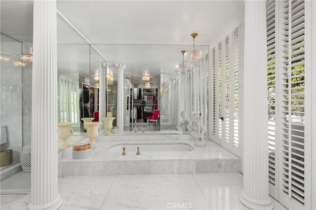 full bath featuring a bath, ornate columns, a shower, a notable chandelier, and marble finish floor