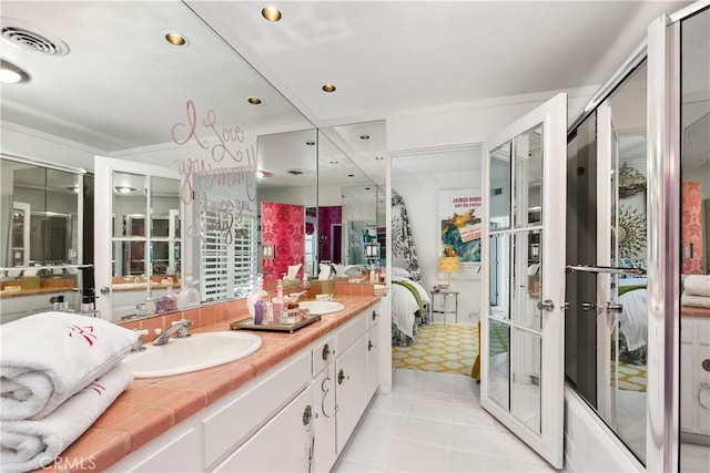 bathroom with visible vents, double vanity, recessed lighting, ensuite bath, and a sink