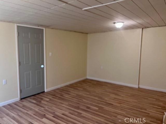 basement with hardwood / wood-style flooring