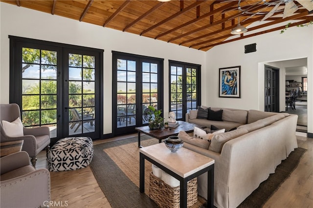 living room with wooden ceiling, french doors, lofted ceiling with beams, and hardwood / wood-style flooring