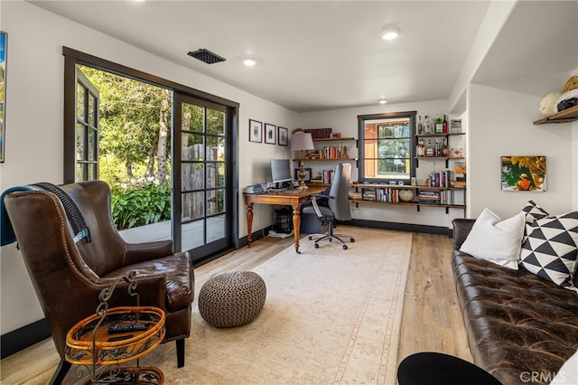 office space with wood-type flooring