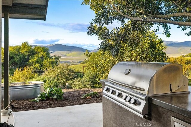 view of patio / terrace featuring a mountain view and a grill