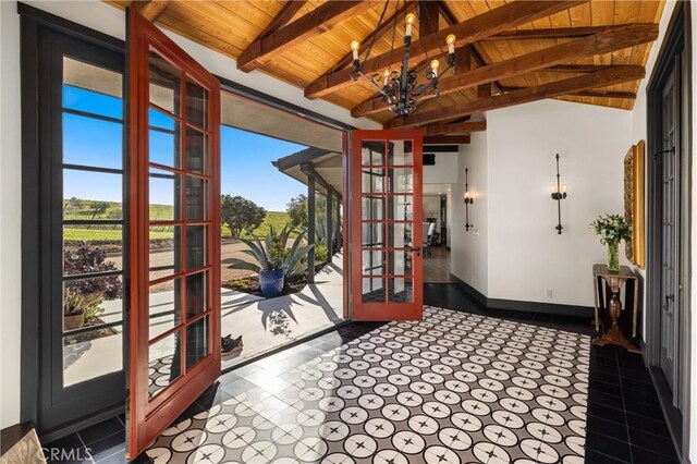 interior space with wooden ceiling, lofted ceiling with beams, a chandelier, and french doors