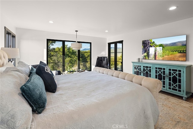 bedroom featuring multiple windows and hardwood / wood-style floors