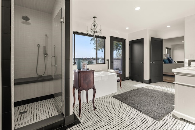 bathroom featuring tile flooring, separate shower and tub, vanity, and an inviting chandelier