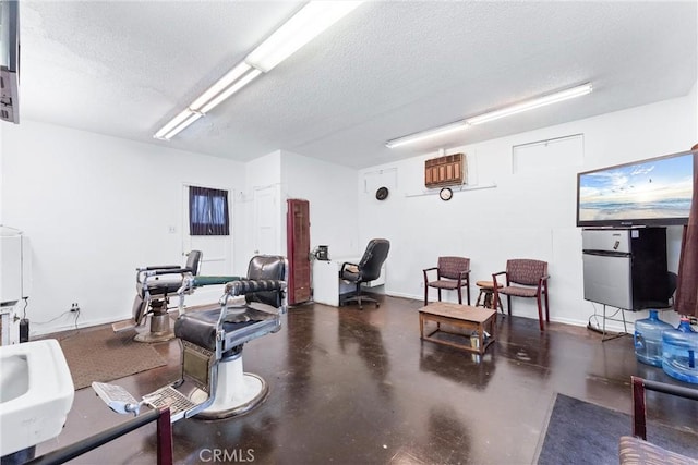 exercise room with a textured ceiling