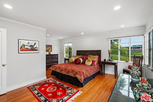 bedroom with crown molding and hardwood / wood-style floors