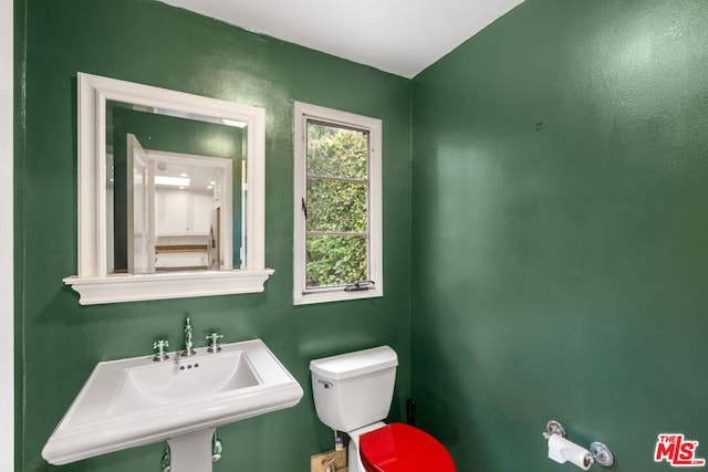 bathroom featuring sink and toilet