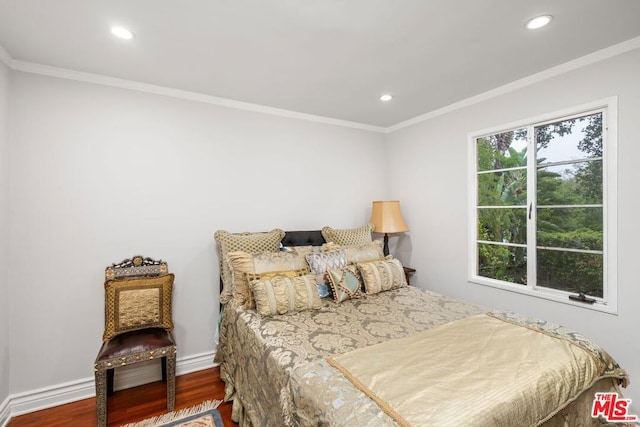 bedroom with crown molding and dark wood-type flooring