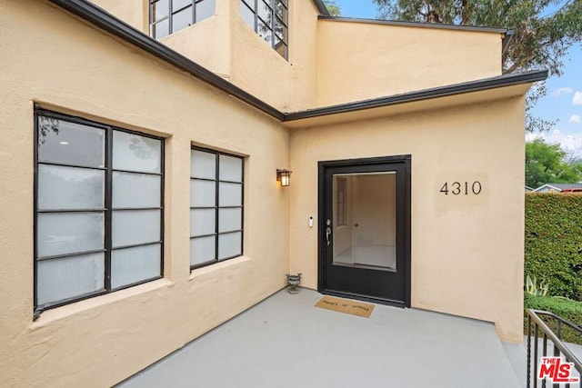 doorway to property with a patio area