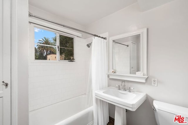 bathroom with shower / bathtub combination with curtain and toilet