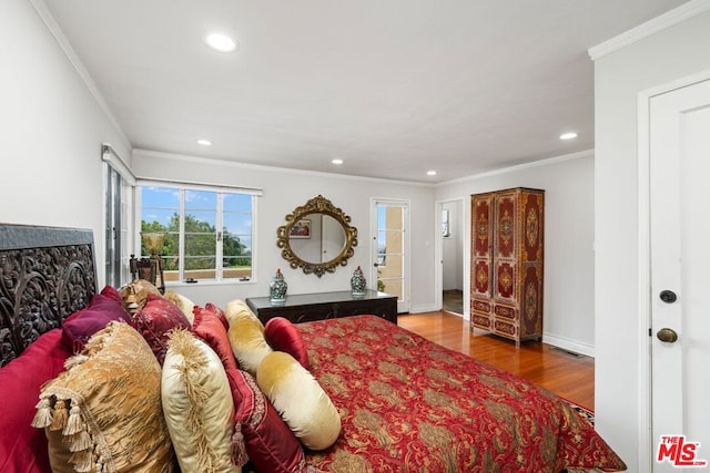 bedroom featuring ornamental molding and wood-type flooring