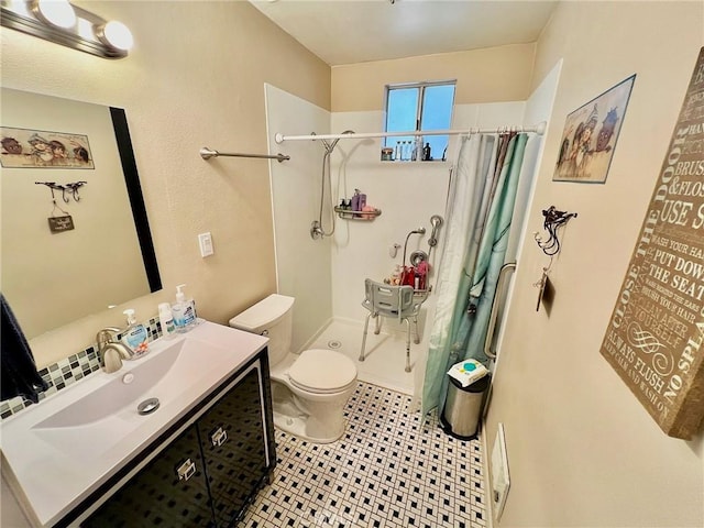 bathroom with toilet, a shower with curtain, vanity, and tile patterned floors