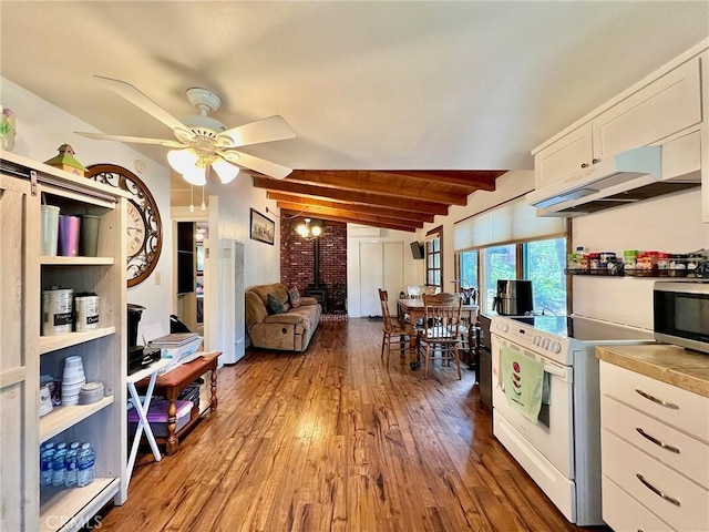 kitchen with hardwood / wood-style floors, a wood stove, white cabinets, ceiling fan, and white range with electric stovetop