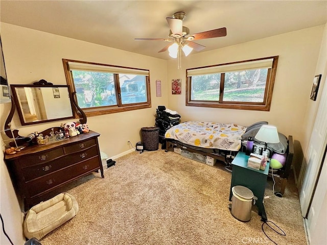 bedroom featuring carpet flooring, multiple windows, and ceiling fan