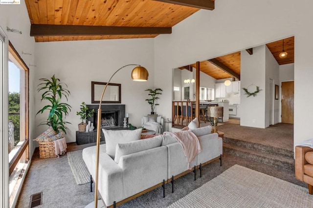 carpeted living room featuring beamed ceiling, high vaulted ceiling, and wooden ceiling