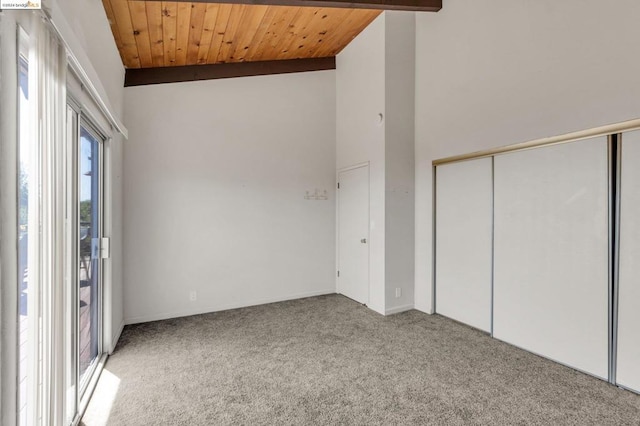 interior space with lofted ceiling with beams, carpet floors, and wooden ceiling