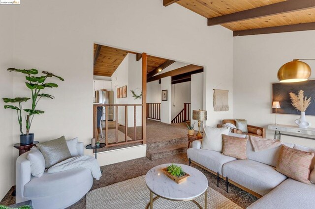 carpeted living room featuring lofted ceiling with beams and wood ceiling