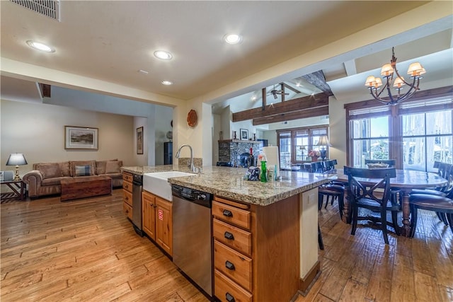 kitchen with dishwasher, sink, hanging light fixtures, light hardwood / wood-style flooring, and a notable chandelier