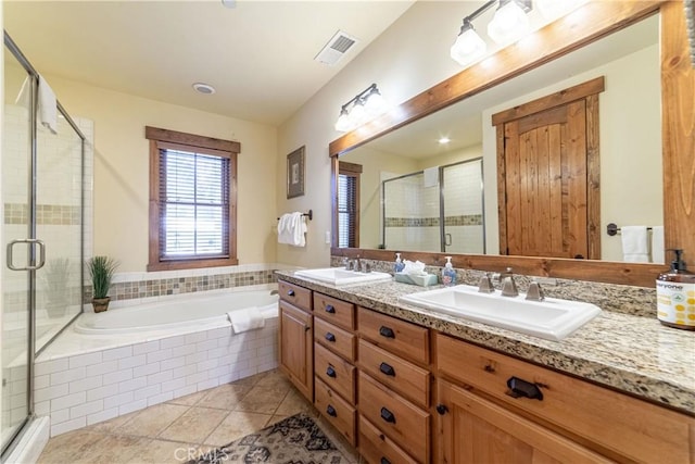 bathroom featuring plus walk in shower, vanity, and tile patterned floors