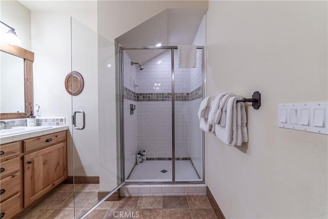 bathroom featuring vanity and an enclosed shower