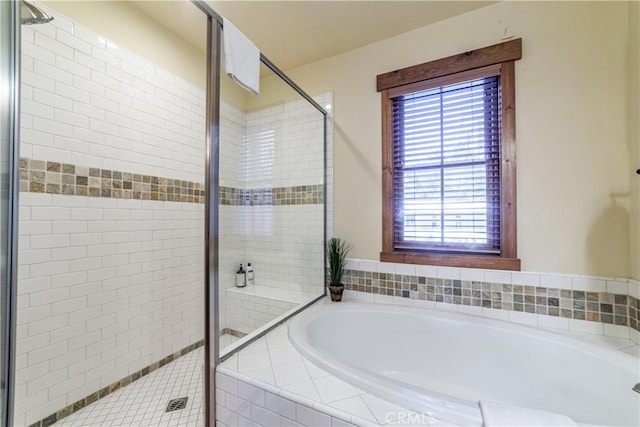 bathroom with shower with separate bathtub