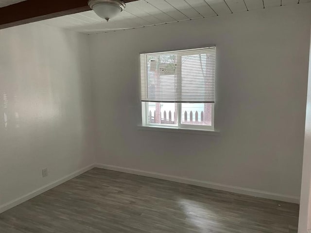 unfurnished room with plenty of natural light and dark wood-type flooring