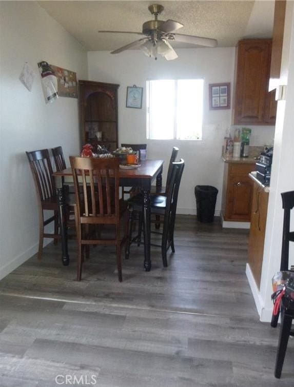 dining room with ceiling fan and dark hardwood / wood-style flooring