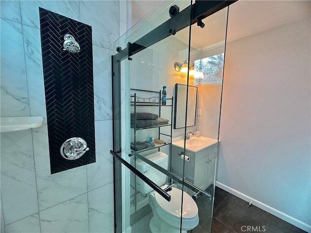 bathroom with vanity, a tile shower, and toilet